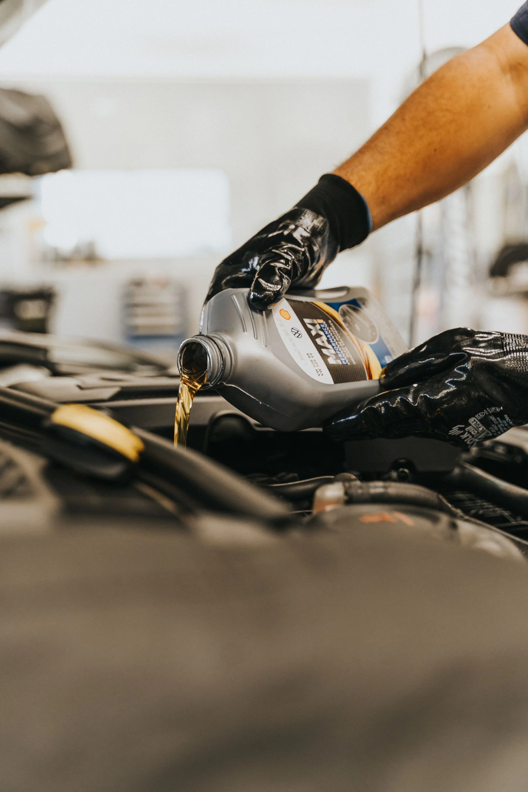 Engine oil poured from a bottle during vehicle maintenance